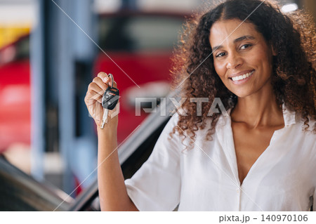 Woman showing car key. Enjoy fix car service. Satisfied car maintenance in garage, Sell Rent car 140970106