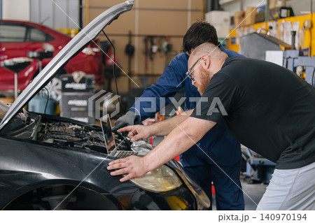 Car engineer technician worker, Technician team use laptop computer for tuning ECU with software. Car engineer technician worker, Technician team use laptop computer for tuning ECU with software. 140970194