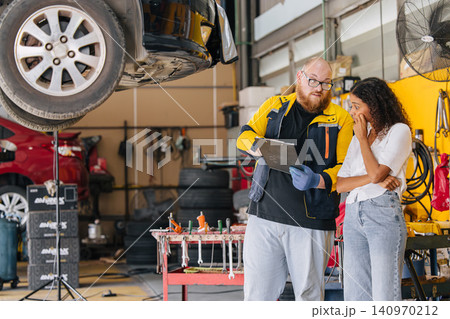 Car engine service in garage workshop, Customer worry talking with mechanic man. Car engine service in garage workshop, Customer worry talking with mechanic man. 140970212