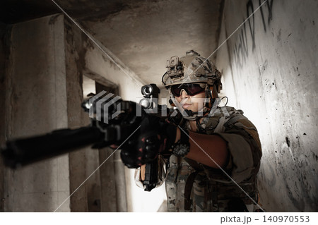Special forces soldier aiming rifle, military tactical operation portrait Special forces soldier aiming rifle, military tactical operation portrait 140970553