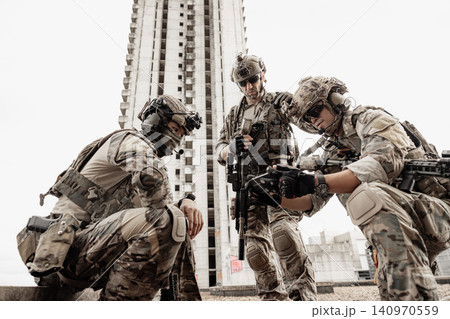 Group of Military Team, Soldiers in camouflage plan attack mission together against the building 140970559