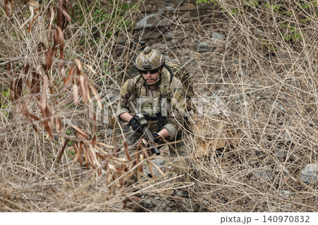 Military rangers, US Marine engaged in jungle combat operation deep in tropical forest 140970832