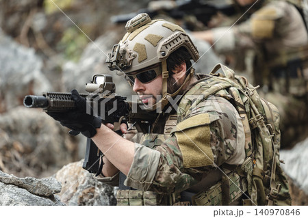 US Marine, Military Special forces soldier under heavy enemy fire intense battlefield engagement US Marine, Military Special forces soldier under heavy enemy fire intense battlefield engagement 140970846