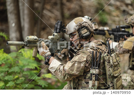 US Special forces soldiers engaged in combat operation, tactical military team in action US Special forces soldiers engaged in combat operation, tactical military team in action 140970950