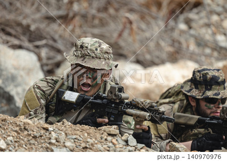 US Marine, Military Special forces soldier under heavy enemy fire intense battlefield engagement US Marine, Military Special forces soldier under heavy enemy fire intense battlefield engagement 140970976