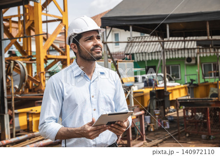 Asian Indian construction Engineer male, Builder lead construction site working control operate site. Asian Indian construction Engineer male, Builder lead construction site working control operate site. 140972110
