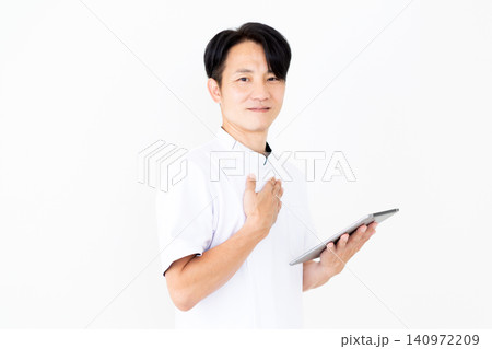 タブレットを持つ白衣を着たミドル男性の鍼灸師・整体師 タブレットを持つ白衣を着たミドル男性の鍼灸師・整体師 140972209