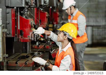 Professional Engineer team workers cleaning service repair old heavy metal machine in metal factory. Professional Engineer team workers cleaning service repair old heavy metal machine in metal factory. 140972313