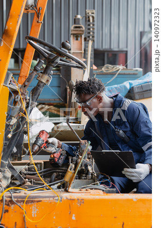 Black African young worker man working fix service repair industry vehicle electricity wiring Black African young worker man working fix service repair industry vehicle electricity wiring 140972323