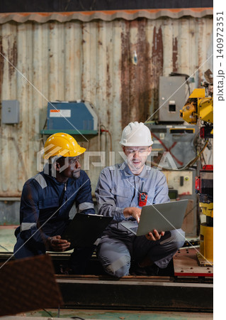 Professional engineer workers team working in metal workshop talking and working together Professional engineer workers team working in metal workshop talking and working together 140972351