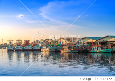 Colorful Fishing Boats Moored at Peaceful Harbor During Sunset Colorful Fishing Boats Moored at Peaceful Harbor During Sunset 140972472