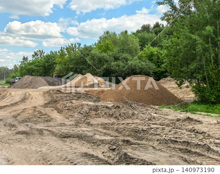 Large piles of sand and soil at construction site on sunny summer day 140973190