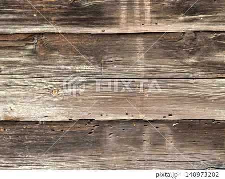 Old weathered wooden plank wall texture with wormholes Old weathered wooden plank wall texture with wormholes 140973202