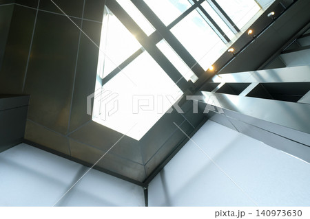 The low angle view of the building ceiling. Interior of modern architecture, modern city building. Interior design. Details of modern architecture. Building abstract. Building background. The low angle view of the building ceiling. Interior of modern architecture, modern city building. Interior design. Details of modern architecture. Building abstract. Building background. 140973630