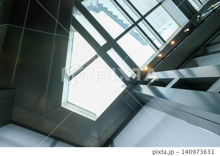 The low angle view of the building ceiling. Interior of modern architecture, modern city building. Interior design. Details of modern architecture. Building abstract. Building background. 140973631