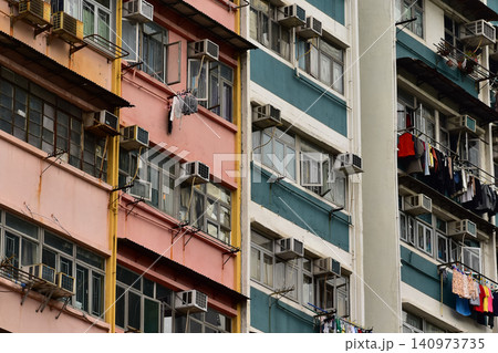 Close-up of the residential building's window in Hong Kong. The cityscape of Hong Kong. Urban development. Details of modern architecture. Building abstract. Building background. Close-up of the residential building's window in Hong Kong. The cityscape of Hong Kong. Urban development. Details of modern architecture. Building abstract. Building background. 140973735
