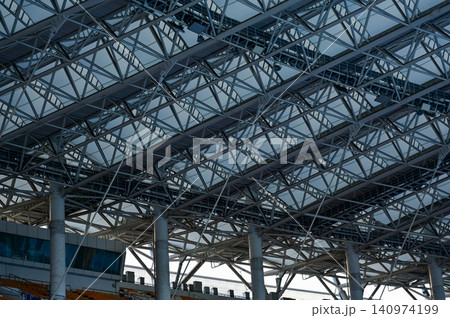 Close-up of the stadium ceiling. Modern architecture, modern city building. Exterior design. Details of modern architecture. Building abstract. Building background. Close-up of the stadium ceiling. Modern architecture, modern city building. Exterior design. Details of modern architecture. Building abstract. Building background. 140974199