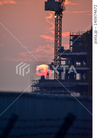 Crane truck working in construction site with sky background. Crane against sky. Crane, Construction background, construction equipment crane background. Crane truck working in construction site with sky background. Crane against sky. Crane, Construction background, construction equipment crane background. 140974672