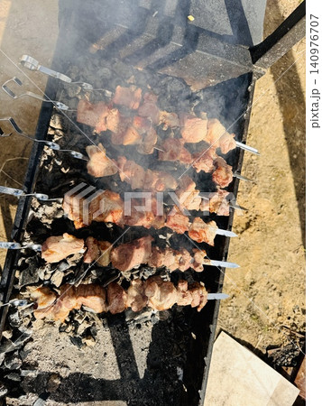 Top-down view of a grill with sizzling shashlik skewers Top-down view of a grill with sizzling shashlik skewers 140976707