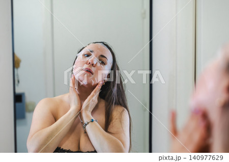 Beauty Portrait of Woman Applying Face Cream 140977629