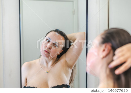 Beauty Portrait of Woman Applying Face Cream 140977630