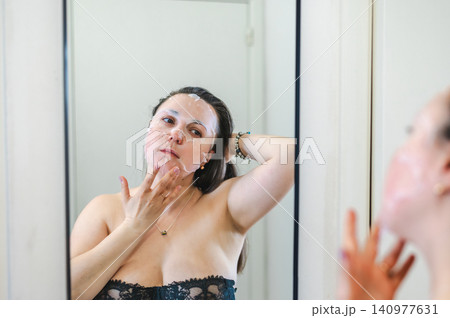 Beauty Portrait of Woman Applying Face Cream Beauty Portrait of Woman Applying Face Cream 140977631