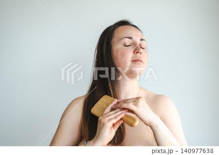 Woman Combing Hair - Daily Beauty Routine Woman Combing Hair - Daily Beauty Routine 140977638