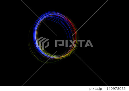 Bright colors create a beautiful circle of light, capturing motion and energy in a stunning display against a black backdrop Bright colors create a beautiful circle of light, capturing motion and energy in a stunning display against a black backdrop 140978083