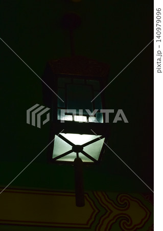 Close-up of the Chinese classical lamp hanging on the ceiling at night. Light bulb. Interior design, decoration. Lighting equipment. Close-up of the Chinese classical lamp hanging on the ceiling at night. Light bulb. Interior design, decoration. Lighting equipment. 140979096