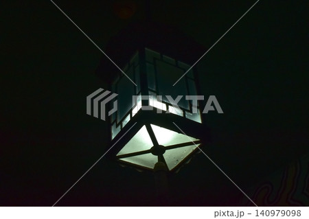 Close-up of the Chinese classical lamp hanging on the ceiling at night. Light bulb. Interior design, decoration. Lighting equipment. Close-up of the Chinese classical lamp hanging on the ceiling at night. Light bulb. Interior design, decoration. Lighting equipment. 140979098