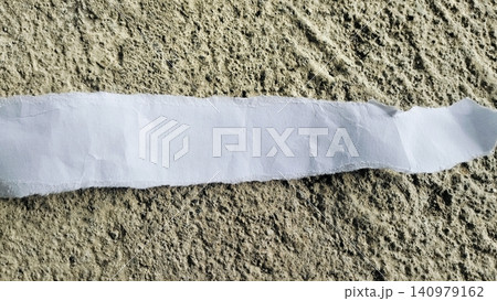 Torn White Paper Strip on Rough Gray Concrete Texture Background Torn White Paper Strip on Rough Gray Concrete Texture Background 140979162