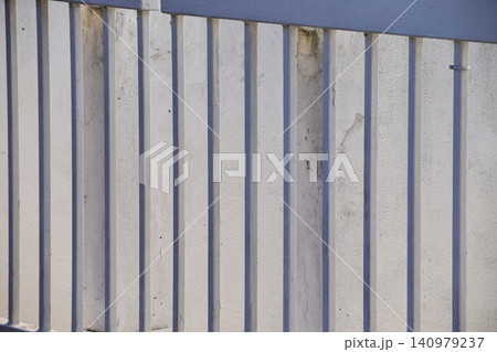 Close-up of metal corrugated board. Fence from corrugated board. Texture of metal fence. For background use. Close-up of metal corrugated board. Fence from corrugated board. Texture of metal fence. For background use. 140979237