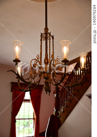 Gold vintager chandelier light in a room for interior decoration. Chandelier Candlestick. Crystal chandelier, intricately designed golden chandelier with radiant bulbs illuminating. Gold vintager chandelier light in a room for interior decoration. Chandelier Candlestick. Crystal chandelier, intricately designed golden chandelier with radiant bulbs illuminating. 140979284