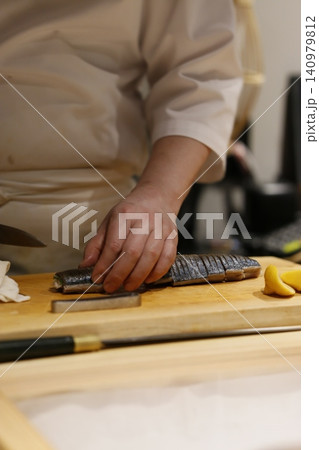 Chef Preparing Sushi on Wooden Board Chef Preparing Sushi on Wooden Board 140979812