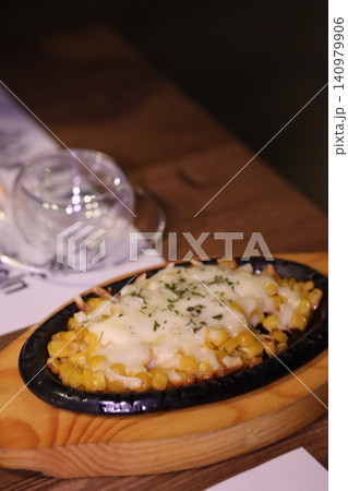 Cheesy Corn Dish on Wooden Tray 140979906