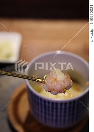 Shrimp on Gold Spoon with Bowl in Background 140980021
