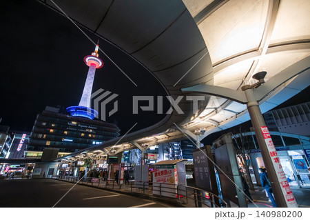 Bus station platform with curve roof by Kyoto tower at night, Japan Bus station platform with curve roof by Kyoto tower at night, Japan 140980200