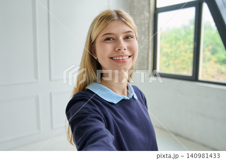 Smiling teen girl aged 16-17 taking a selfie Smiling teen girl aged 16-17 taking a selfie 140981433