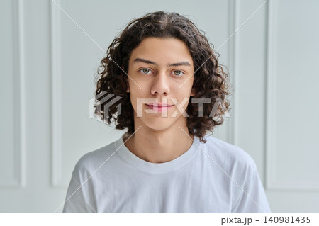 Close up of calm teen boy looking at camera Close up of calm teen boy looking at camera 140981435