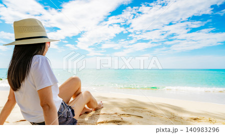 Woman enjoying a tranquil seaside on a sunny tropical beach with turquoise water, soft sand. Summer vacation travel, leisure, coastal destination, and relaxation background. Wellness retreat, tourism. Woman enjoying a tranquil seaside on a sunny tropical beach with turquoise water, soft sand. Summer vacation travel, leisure, coastal destination, and relaxation background. Wellness retreat, tourism. 140983296