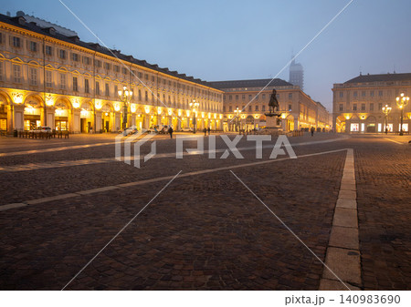 Turin, piedmont, italy. November 20, 2024. Piazza san carlo, a historic square in turin, italy, illuminated by streetlights and building lights in the fog Turin, piedmont, italy. November 20, 2024. Piazza san carlo, a historic square in turin, italy, illuminated by streetlights and building lights in the fog 140983690