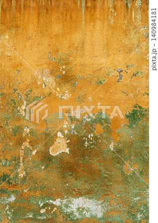 shabby orange and green painted wall of house 140984181