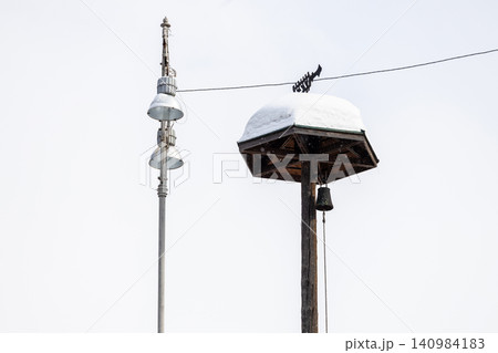 modern and old snow-covered wooden alarm tower 140984183