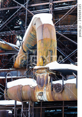 pipeline in factory courtyard during snowfall 140984185