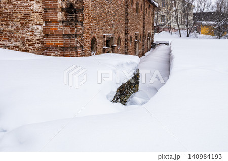 deep snowdrift near brick building during snowfall deep snowdrift near brick building during snowfall 140984193