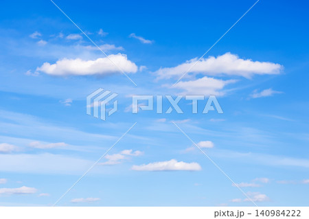 few small cirrus and cumulus clouds in blue sky few small cirrus and cumulus clouds in blue sky 140984222