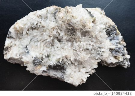 druze of white and clear quartz rock on black druze of white and clear quartz rock on black 140984438