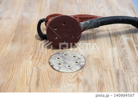 polishing machine and old sandpaper disk on table polishing machine and old sandpaper disk on table 140984507