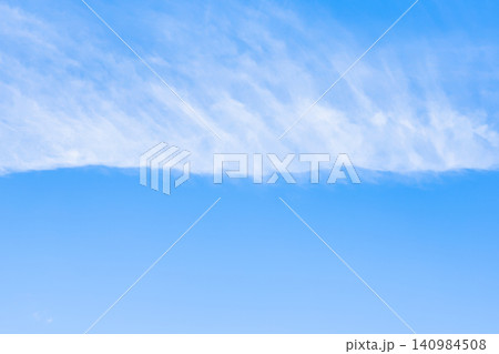 horizontal front of cirrus clouds in blue sky 140984508