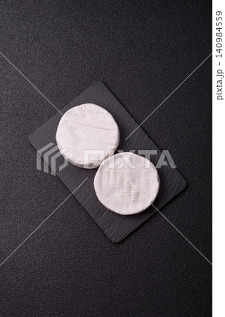 Brie or Camembert cheese is a white, round shape for baking and melting. Camembert cheese 140984559
